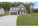 Charming two-story home boasts a well-manicured lawn, attached garage, and welcoming front porch at 404 Beacon Way, Villa Rica, GA 30180