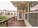 Relaxing covered balcony with a view of the community, showcasing wood flooring and neutral siding at 2382 Gallard St, Lawrenceville, GA 30043