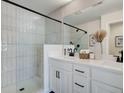 Elegant bathroom with glass-enclosed shower, double vanity, and modern fixtures at 1899 Deco Dr, Kennesaw, GA 30144