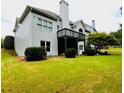 Back of home features a wooden deck, a large yard, and plenty of natural light at 306 Mountain Laurel Walk, Canton, GA 30114