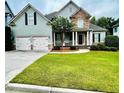 Inviting two-story home boasts a well-kept lawn, two-car garage, and covered front porch at 306 Mountain Laurel Walk, Canton, GA 30114