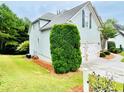 Home featuring light siding, white trim, garage, and landscaped yard with green lawn at 306 Mountain Laurel Walk, Canton, GA 30114