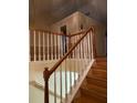 Wooden staircase with white spindles and hardwood floors at 6922 Magnolia Park Dr, Norcross, GA 30093