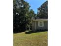 House exterior showcasing a side view with lush green surroundings at 130 Taunton Rd, Covington, GA 30014