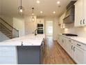 Spacious kitchen with island, white cabinets, and marble countertops at 1129 Red Oak Blvd, Loganville, GA 30052