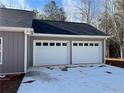 Spacious three-car garage with modern white doors and ample parking space on the driveway at 1250 Adamson Rd, Bowdon, GA 30108