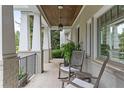 Welcoming front porch showcases white columns, a brick base, and comfortable seating with views of the neighborhood at 2908 Mabry Ne Ln, Brookhaven, GA 30319