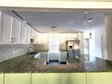 Modern kitchen with granite countertops, stainless steel appliances and Herringbone backsplash at 2924 Sylvan Rd, East Point, GA 30344