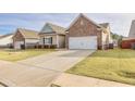 Charming one-story home featuring brick and siding exterior, manicured lawn and a two car garage at 4444 Kendrick Cir, Loganville, GA 30052