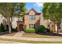 Brick two-story house with landscaping and walkway at 7470 Flintlock Way, Alpharetta, GA 30005