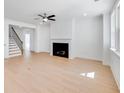 Bright living room with a fireplace, hardwood floors, and ample natural light at 41 Bennett Farm Dr, Loganville, GA 30052