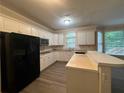 Bright kitchen with island, stainless steel appliances, and light-colored cabinetry at 1824 Thornhill Se Pass, Conyers, GA 30013