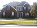 Charming two-story brick home featuring manicured landscaping and a welcoming facade at 989 Park Knoll Ct, Lawrenceville, GA 30043