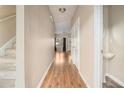 Inviting hallway featuring hardwood floors, neutral walls, and a view into the living area, showcasing the home's open layout at 5100 Windsor Forrest Ln, Atlanta, GA 30349
