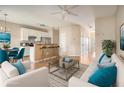 Bright, open living room with modern furniture, flowing into a kitchen with stainless steel appliances and breakfast bar at 5100 Windsor Forrest Ln, Atlanta, GA 30349