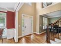 Bright entryway with hardwood floors and white front door at 625 Jefferson Pl, Cumming, GA 30040