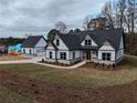 Two-story farmhouse with gray roof, white siding, and stone accents at 2259 County Line Rd, Acworth, GA 30101