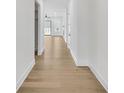 Bright hallway with hardwood floors leading into a spacious home with natural light and neutral decor at 229 Mooney Rd, Woodstock, GA 30188