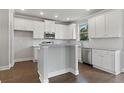 Modern kitchen with white cabinets, granite countertops, stainless steel appliances, and hardwood floors at 6061 Spring Way, Stonecrest, GA 30038
