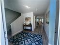 Inviting entryway featuring a decorative rug, wooden floors, and a console table with stylish decor at 3290 Forest Green Dr, Douglasville, GA 30135
