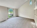 Sun-filled living room with neutral carpet and a large window at 320 Rebecca Lake Way, Fairburn, GA 30213