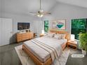 Spacious main bedroom with a ceiling fan, ensuite bathroom and bright window views at 320 Rebecca Lake Way, Fairburn, GA 30213