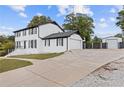 Inviting two-story home featuring a driveway, garage, and a large grassy yard at 3636 Evans Rd, Atlanta, GA 30340