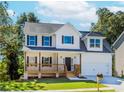 Charming two-story home with a covered front porch and a well-manicured lawn at 6462 Beaver Creek Trl, Atlanta, GA 30349