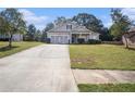 Inviting single Gathering home featuring a large driveway and attached two car garage at 421 Bedford Xing, Mcdonough, GA 30253