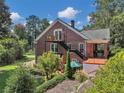The exterior view of home features a porch, balcony, and landscaped yard at 133 Hillside Se Ave, Atlanta, GA 30315