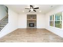 Bright living room features beautiful floors, large windows and a charming brick fireplace at 1254 Red Oak Blvd, Loganville, GA 30052