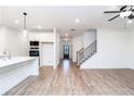 Spacious living area featuring wood floors, a staircase, recessed lighting and an open floor plan at 1254 Red Oak Blvd, Loganville, GA 30052