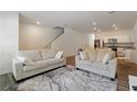 Bright living room with modern furniture and hardwood floors, flowing into the kitchen at 2688 Toucan Way, Atlanta, GA 30331