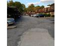 Wide view of the community parking lot with covered parking spots, landscaping and unit exteriors visible at 3014 Parc Lorraine Cir # 3014, Lithonia, GA 30038