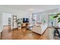 Light-filled living room with hardwood floors and access to balcony at 50 Biscayne Nw Dr # 3110, Atlanta, GA 30309