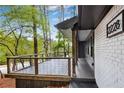 Close up of covered front porch with wood and metal railing and painted brick and siding at 2228 Old Dallas Sw Rd, Marietta, GA 30064