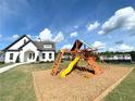 Community playground with playset and clubhouse in the background at 94 S Auburn Landing Pl, Auburn, GA 30011