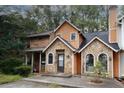 Beautiful townhouse with stone and wood exterior, featuring arched windows, a cozy entrance, and a well-maintained facade at 840 Brandy Oaks Ln, Stone Mountain, GA 30088