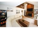 Stylish living room featuring a stone fireplace, modern sectional sofa, and a striking vaulted ceiling with an upper level loft at 840 Brandy Oaks Ln, Stone Mountain, GA 30088