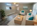 Bright living room featuring modern furniture, neutral paint, and wood-look flooring at 32 Sherwood Loop, Mcdonough, GA 30253