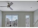 Bright living room featuring neutral walls, a modern ceiling fan, and large windows with blinds at 3160 Mill Springs Cir, Buford, GA 30519