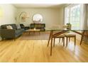Bright living room with hardwood floors, a couch, and a large window providing lots of natural light at 246 Plantation Sw Rd, Smyrna, GA 30082