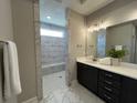Modern bathroom featuring a glass enclosed marble shower with white countertop vanity at 3587 Fishpond Cir, Dacula, GA 30019