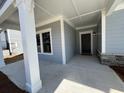 Welcoming front porch featuring a gray-toned entrance with stone accents on the adjacent wall at 3587 Fishpond Cir, Dacula, GA 30019
