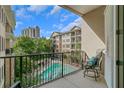 A private balcony offers scenic views of the pool and surrounding landscape at 3621 Vinings Slope Se # 3411, Atlanta, GA 30339
