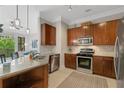 Modern kitchen featuring stainless steel appliances, granite countertops, and dark wood cabinets at 3621 Vinings Slope Se # 3411, Atlanta, GA 30339
