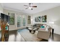 Bright living room with ceiling fan, hardwood floors, comfortable seating, and balcony access at 3621 Vinings Slope Se # 3411, Atlanta, GA 30339
