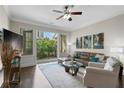 Bright living room with ceiling fan, hardwood floors, comfortable seating, and balcony access at 3621 Vinings Slope Se # 3411, Atlanta, GA 30339