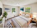 Inviting bedroom featuring two windows for natural light and hardwood floors. (Virtually Staged) at 211 Murphy Ave, Lawrenceville, GA 30044