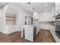 Modern kitchen featuring an island, quartz countertops, stainless steel appliances, and chic pendant lighting at 482 Broom Dr, Cumming, GA 30040